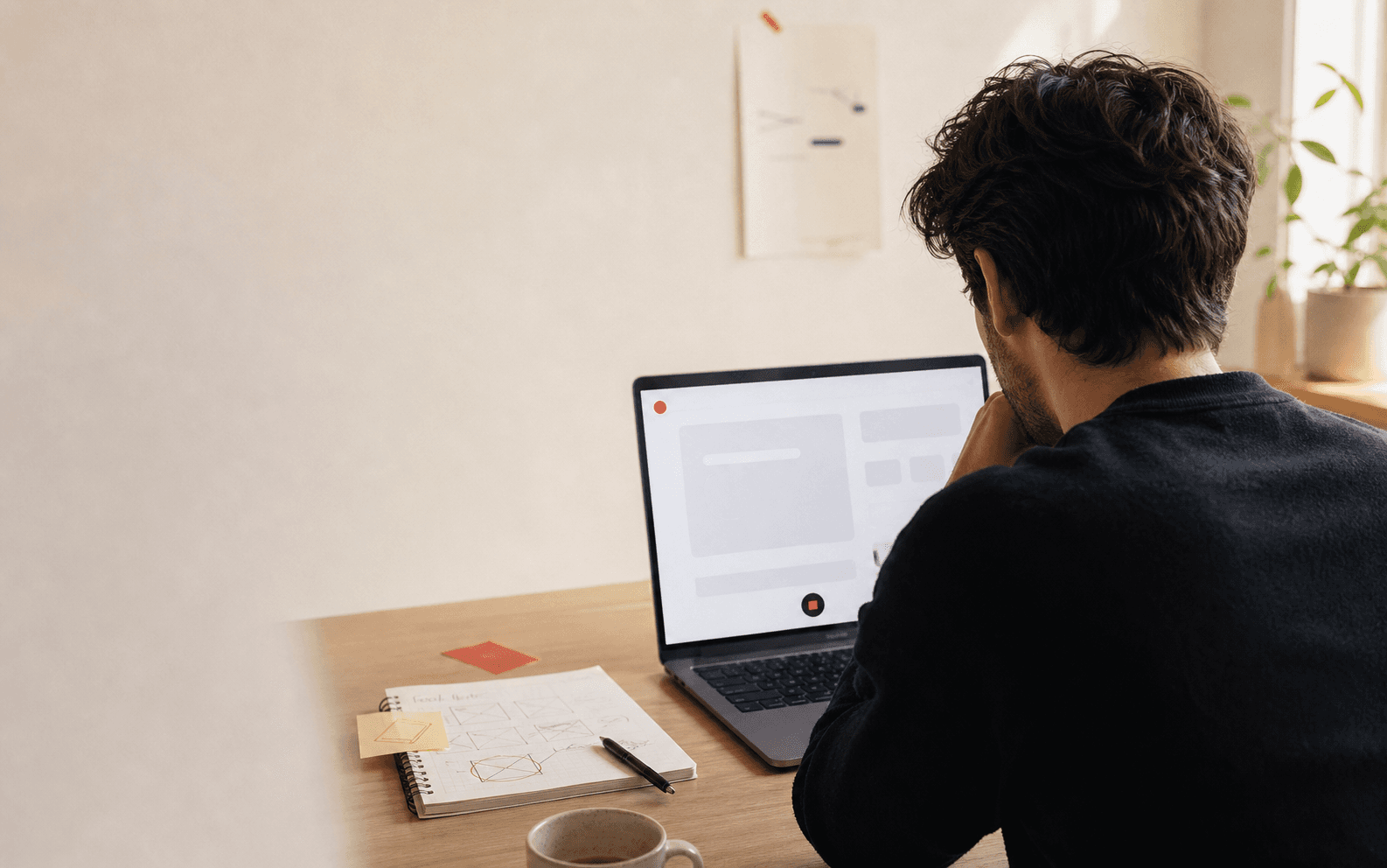 A product reviewer recording feedback at a desk